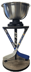 The original WWC1 trophy, with a metal bowl above crossed mini hockey sticks.
